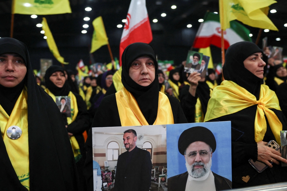 People gather, on the day Lebanon's Hezbollah leader Sayyed Hassan Nasrallah gives a televised address, at a rally commemorating Iran's President Ebrahim Raisi and Foreign Minister Hossein Amirabdollahian who were killed along with other officials in a helicopter crash, in Beirut, Lebanon May 24, 2024. — Reuters pic