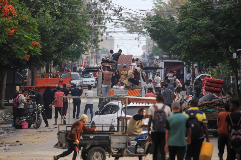 Palestinians flee the area of Tal al-Sultan in Rafah with their belongings following renewed Israeli strikes. — AFP pic