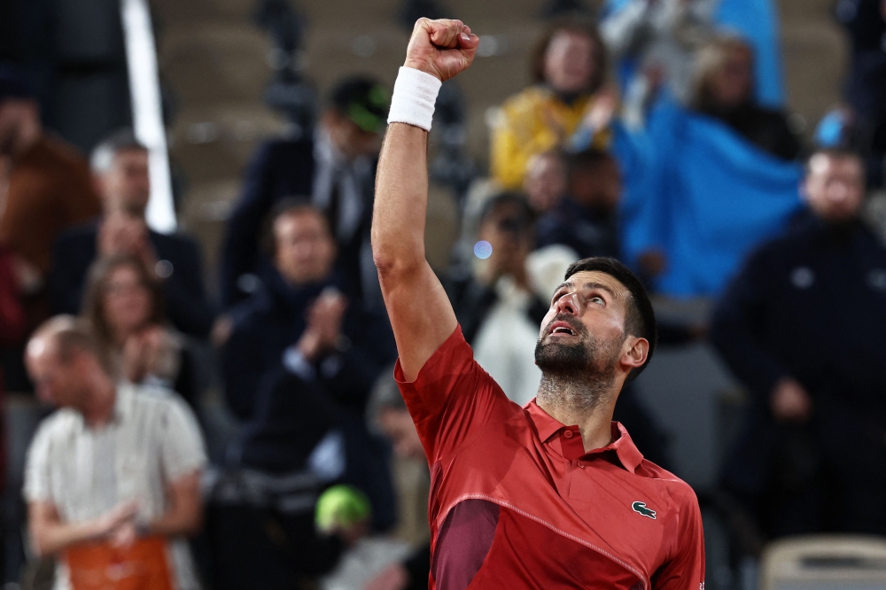 Serbia's Novak Djokovic celebrates after winning against France's Pierre-Hugues Herbert on day three of the French Open tennis tournament at the Roland Garros Complex in Paris May 28, 2024. ― AFP pic