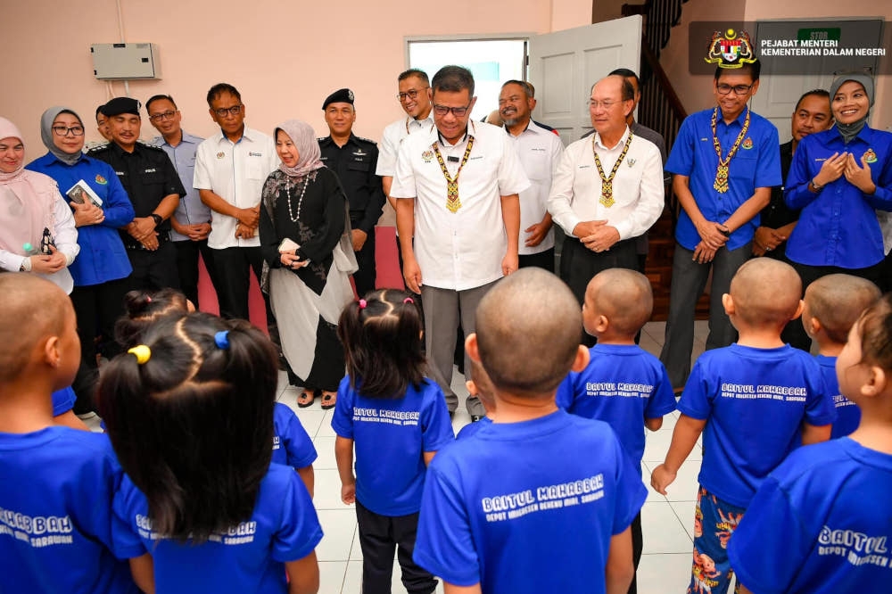 Home Minister Datuk Seri Saifuddin Nasution Ismail with undocumented foreign children at the transit centre in Bekenu, Sarawak, May 30, 2024. — Picture from Facebook/Saifuddin Nasution Ismail 