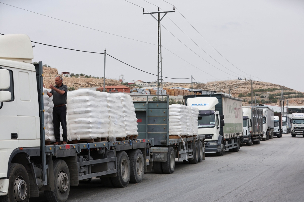 Trucks carrying aid are seen near a checkpoint near Hebron in the Israeli-occupied West Bank May 28, 2024. — Reuters pic