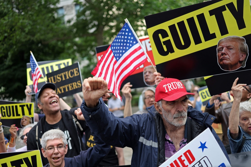 A panel of 12 New Yorkers were unanimous in their determination that Donald Trump is guilty as charged — but for the impact on his election prospects, the jury is still out. — AFP pic