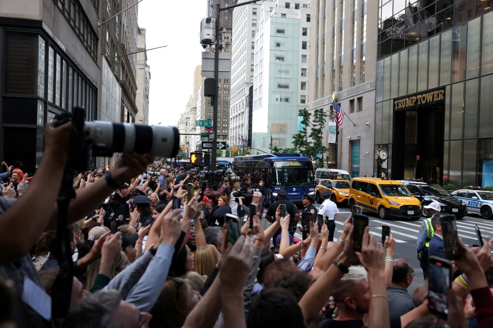 The crowd outside Trump Tower after a New York jury found Donald Trump guilty on Thursday of falsifying documents to cover up a payment to silence a porn star ahead of the 2016 election. — Reuters pic