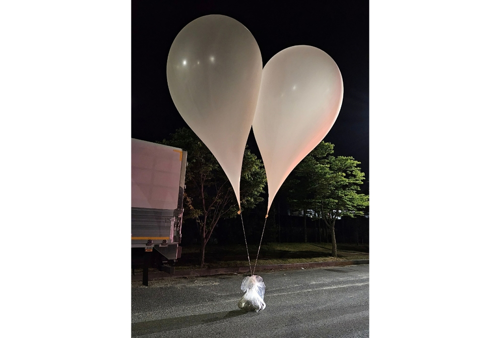 This handout photo taken by the South Korean Defence Ministry between the night of May 28 and 29, 2024 and released on May 29 shows unidentified objects believed to be North Korean propaganda material attached to balloons on a street in Chungnam Province. — AFP pic/South Korean Defence Ministry