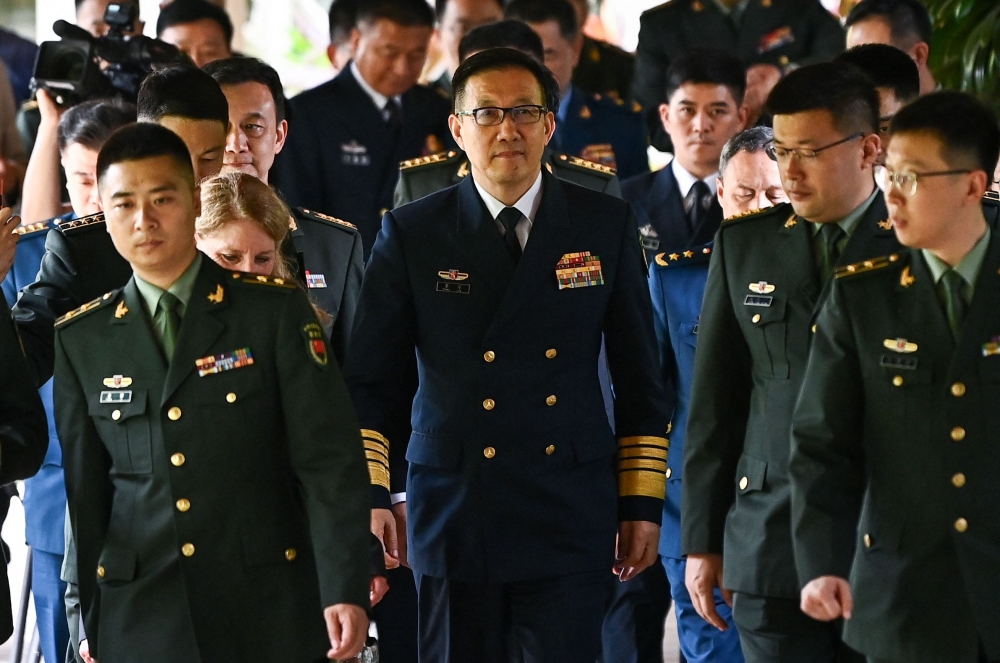China's Defence Minister Dong Jun (centre) walks out after a bilateral meeting with US Secretary of Defence Lloyd Austin on the sidelines of the 21st Shangri-La Dialogue summit at the Shangri-La Hotel in Singapore May 31, 2024. — AFP pic