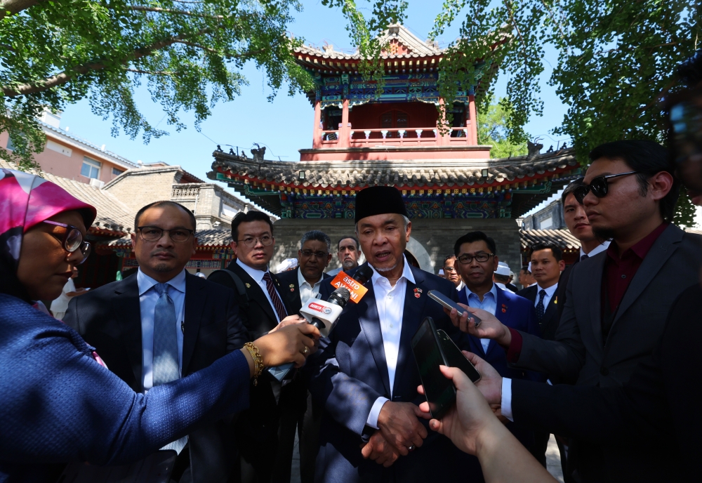 Deputy Prime Minister Datuk Seri Ahmad Zahid Hamidi speaks to reporters after performing Friday prayers at the Dongsi Mosque in Beijing, May 31, 2024. — Bernama  pic 