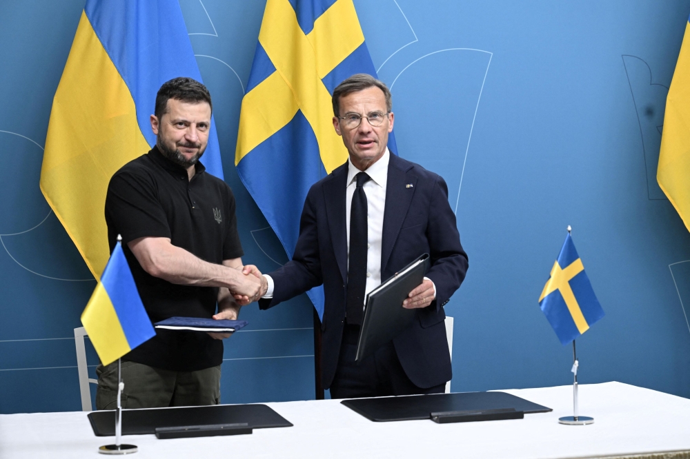 Prime Minister Ulf Kristersson and Ukrainian President Volodymyr Zelenskiy sign bilateral security cooperation with Ukraine in Stockholm, Sweden May 31, 2024. — Fredrik Sandberg/TT News Agency via Reuters 