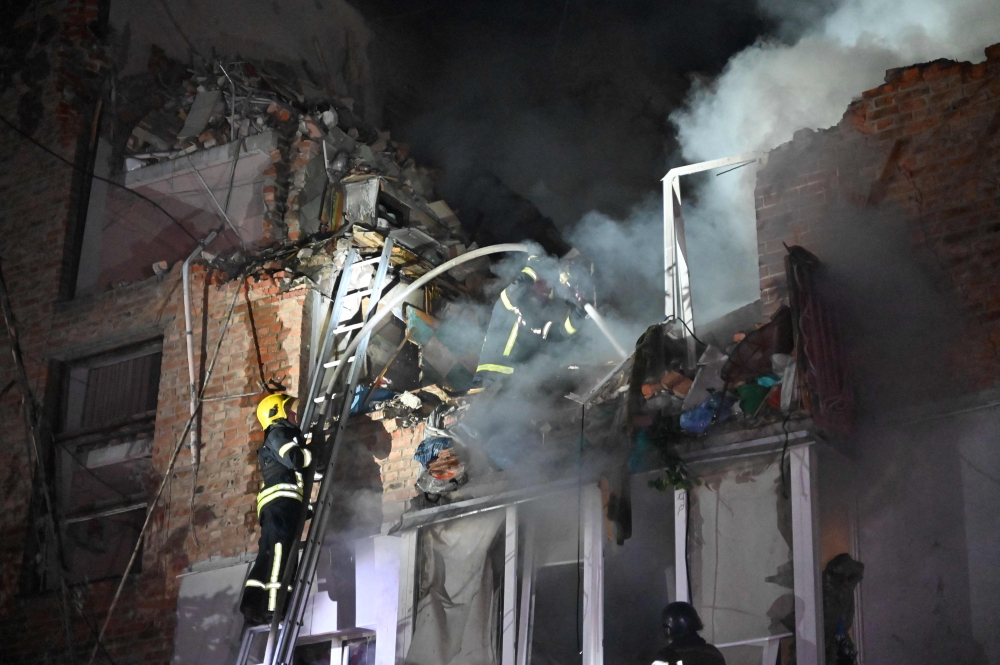 Rescuers extinguish a fire in an apartment building destroyed by a Russian missile attack in Kharkiv early May 31, 2024, amid the Russian invasion in Ukraine. — AFP pic