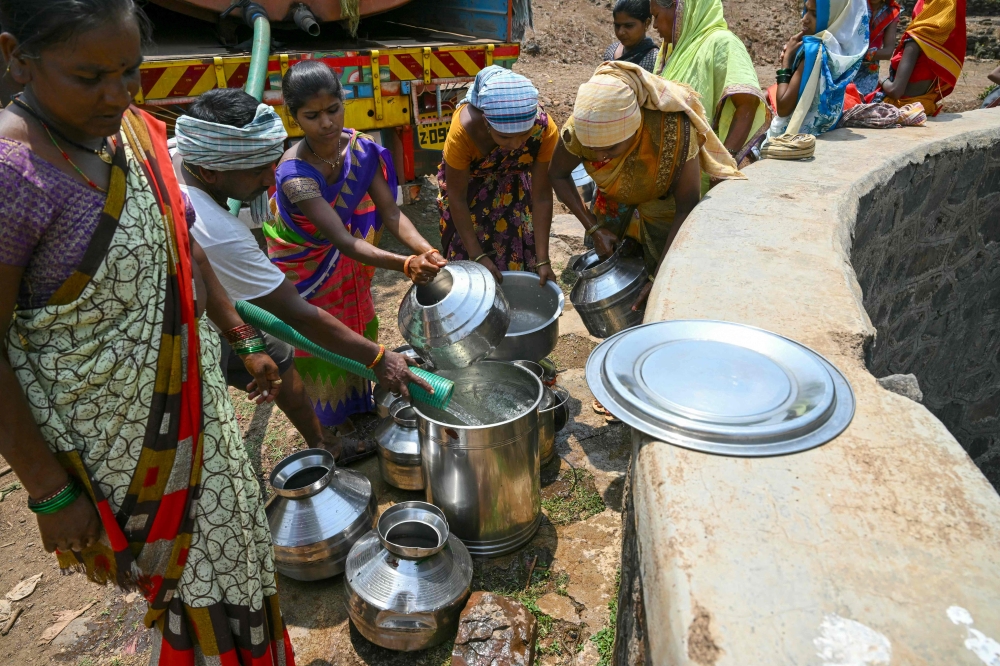 In this file photo taken on May 24, 2024, villagers fill pots with water from a tanker in Shahapur district of India's Maharashtra state, amid ongoing heatwave. — AFP pic