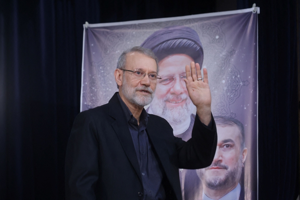 Ali Larijani, former chairman of the parliament of Iran, waves at a press conference after registering as a candidate for the presidential election at the Interior Ministry, in Tehran, Iran May 31, 2024. — Reuters pic
