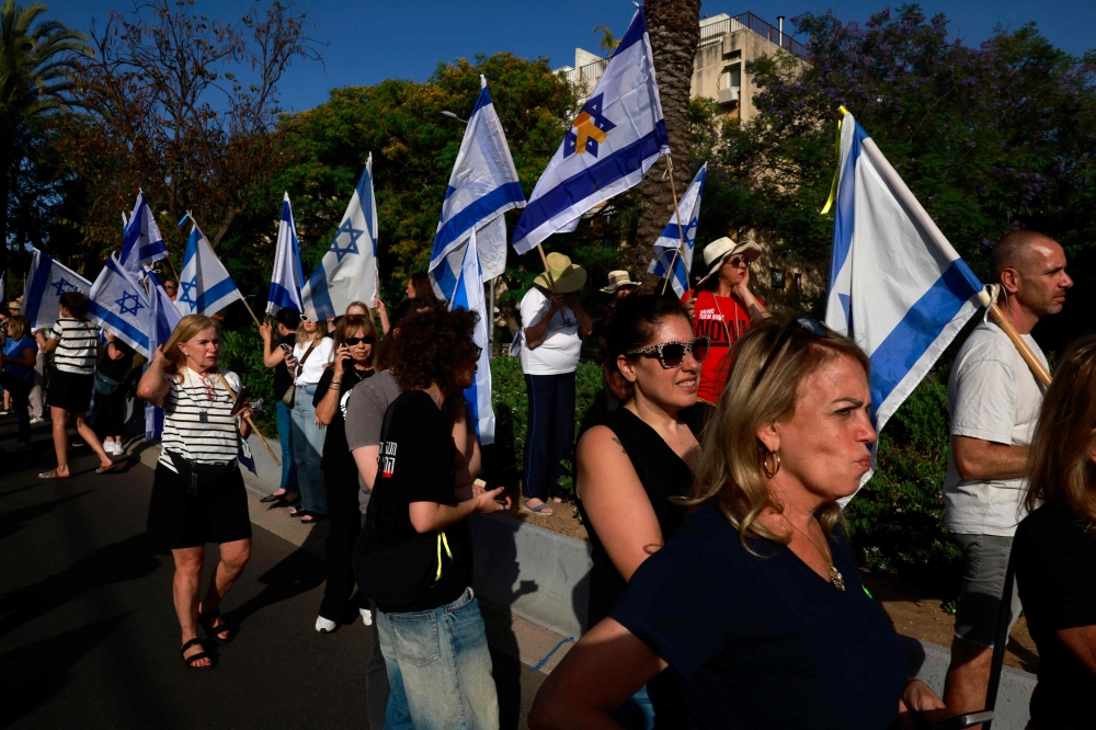 File photo of Israelis attending the funeral of Hanan Yablonka, one of the Israeli hostages held in the Gaza Strip since the October 7, 2023 attack by Palestinian Hamas militants, in Tel Aviv on May 26, 2024, as they also chant slogans demanding the release of the rest of the hostages. — AFP pic