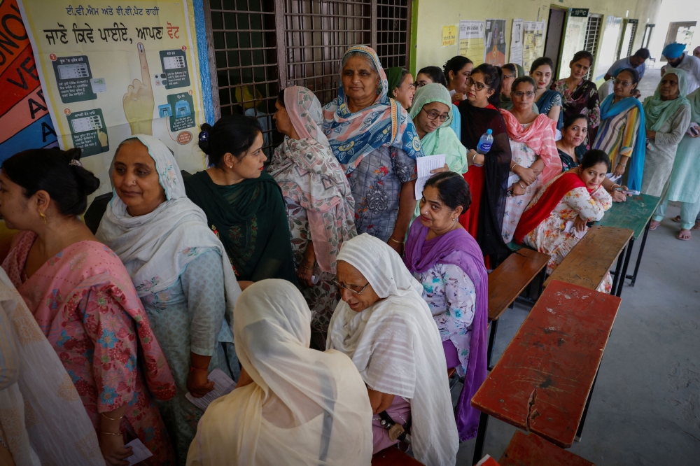 Voters stand in a queue to cast their votes at a polling station during the seventh and last phase of the general election, at a village in Firozpur district, Punjab, India, June 1, 2024. — Reuters pic