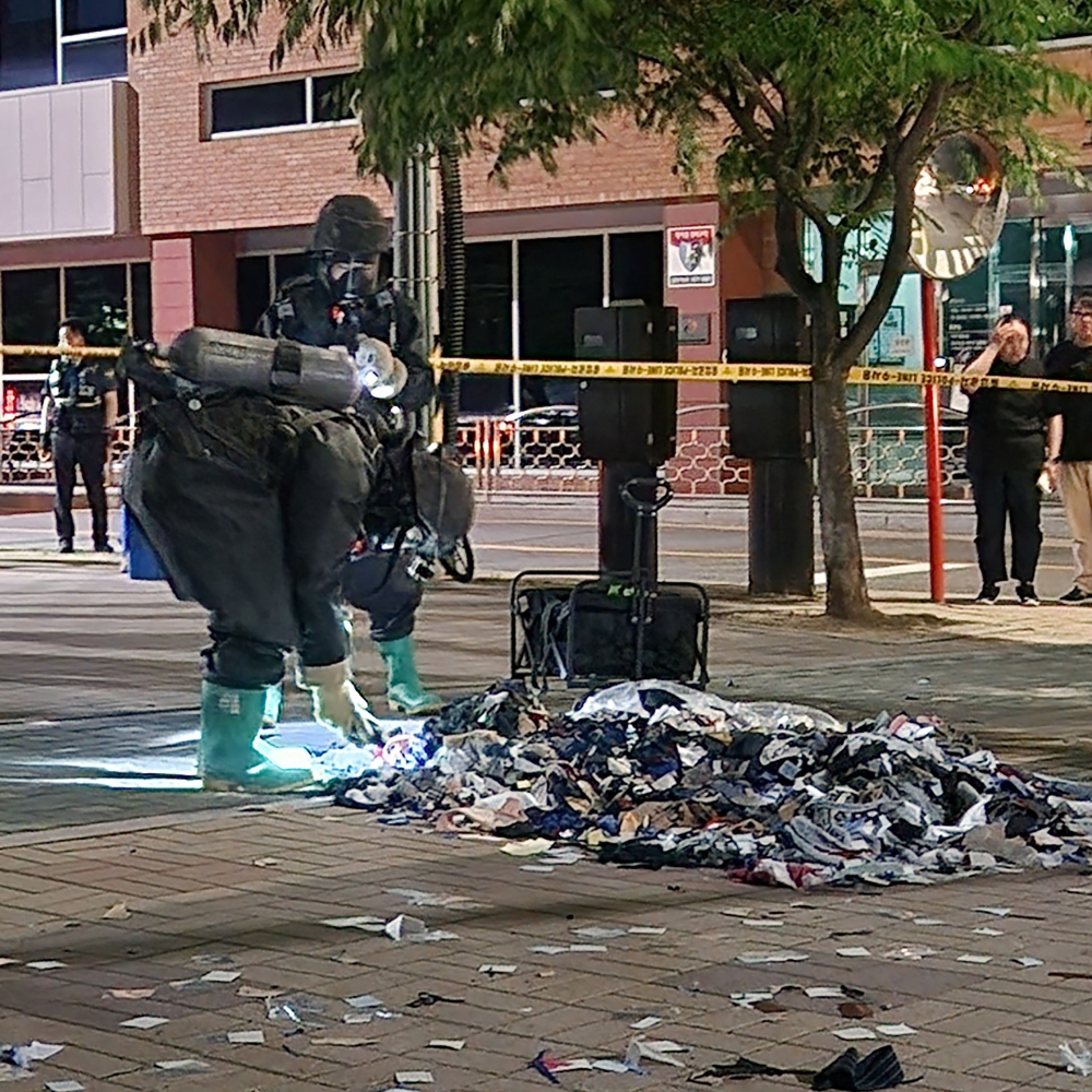 South Korean military officers check unidentified objects believed to be North Korean trash from balloons that crossed the inter-Korea border, on a street in Seoul. 