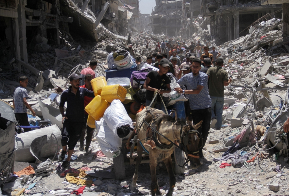 Palestinians make their way, as they inspect the damage after Israeli forces withdrew from Jabalia refugee camp, following a raid, in the northern Gaza Strip, May 31, 2024. — Reuters pic