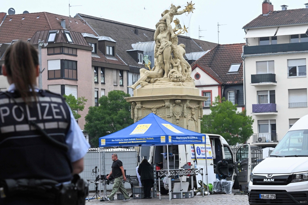 Police secures the area where a police officer died and several people were injured in a knife attack on May 31 in Mannheim. — AFP pic