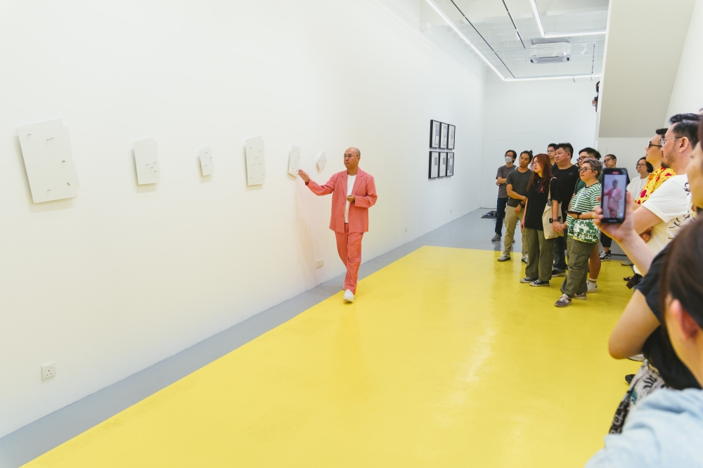 Leong Kwong Yee (left) explains the exhibits at Blank Canvas. — Picture courtesy of Leong Kwong Yee