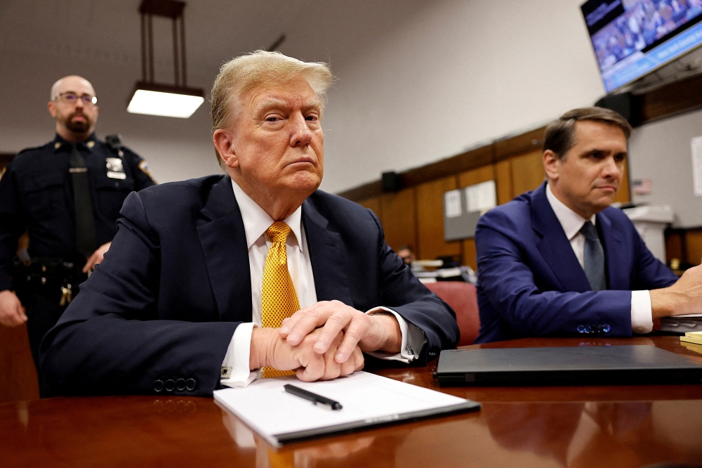 Former US president Donald Trump sits in the courtroom at Manhattan Criminal Court with attorney Todd Blanche on May 21, 2024 in New York City. — Michael M. Santiago/Pool/Reuters pic