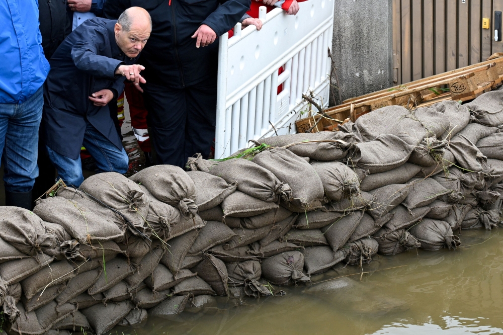 German Chancellor Olaf Scholz gestures as he visits Reichertshofen, in the aftermath of severe flooding, near Ingolstadt, Germany, June 3, 2024. — Reuters pic  