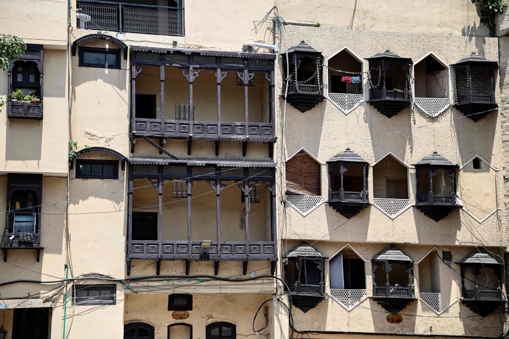 This photograph taken on May 17, 2024 shows balconies and windows of courtesans' haveli or a mansion, where they used to live and perform in the royal neighbourhood of Heera Mandi, a red-light zone, in Lahore. — AFP pic
