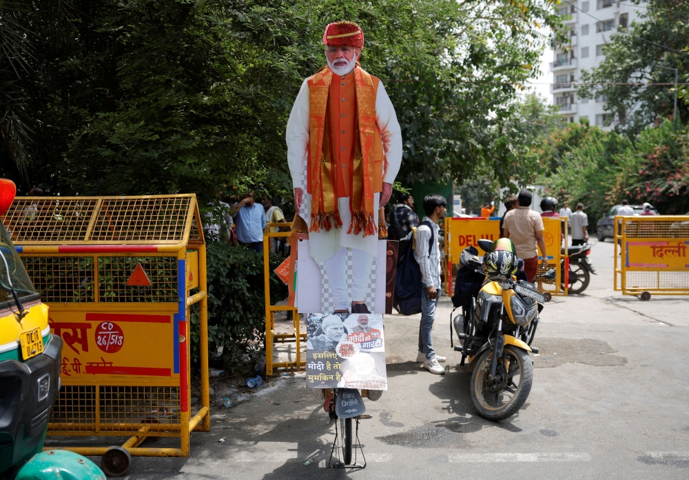 A cutout of Indian Prime Minister Narendra Modi is placed on a bicycle outside the Bharatiya Janata Party (BJP) headquarters, on the day of the general election results, in New Delhi, India, June 4, 2024. — Reuters pic