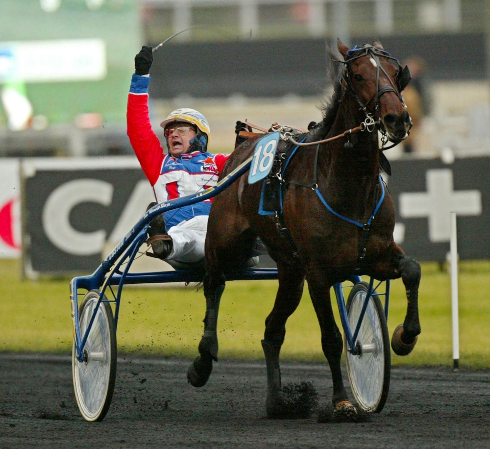 Italian jockey Giampaulo Minucci celebrates his victory as he drives trotter Varenne during the Prix D'Amerique legend race at Vincennes racetrack, outside Paris on January 27, 2002. — AFP file pic