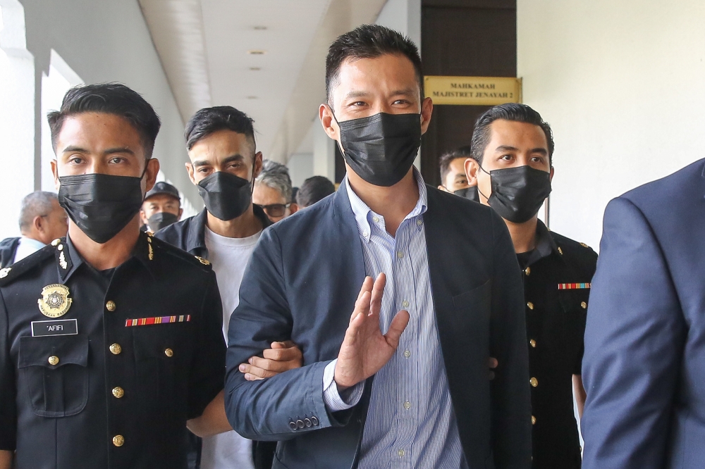 Muhammad Faisal Hamzah (centre), who is the son of Opposition Leader Datuk Seri Hamzah Zainuddin, leaves the courtroom at the Kuala Lumpur Sessions Court June 5, 2024. — Picture by Yusof Mat Isa