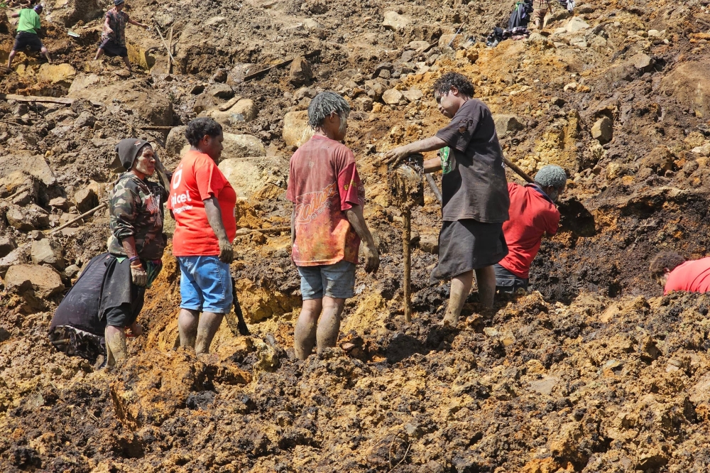 Locals take part during a search and rescue effort at the site of the landslide at Yambali village in the region of Maip Mulitaka in Papua New Guinea on May 30, 2024. — AFP pic