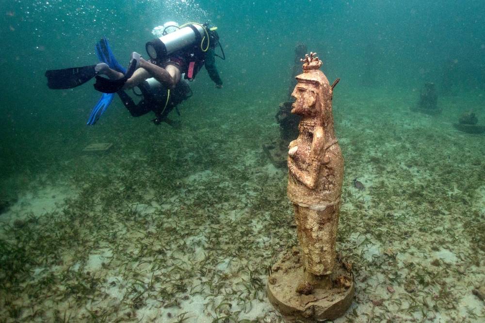 Divers swim next to a sculpture at the Muszif underwater museum in Isla Fuerte. — AFP pic
