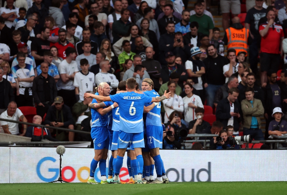 Iceland's Jon Dagur Thorsteinsson celebrates with teammates after scoring the first goal against England June 8, 2024. ― Action Images via Reuters/Andrew Boyers