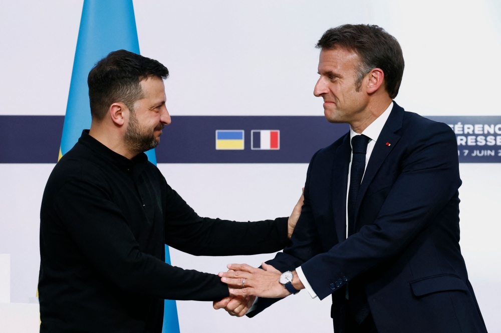 France's President Emmanuel Macron (right) shakes hands with Ukraine's President Volodymyr Zelensky during a joint press conference at the Elysee Palace in Paris on June 7, 2024. ― AFP pic