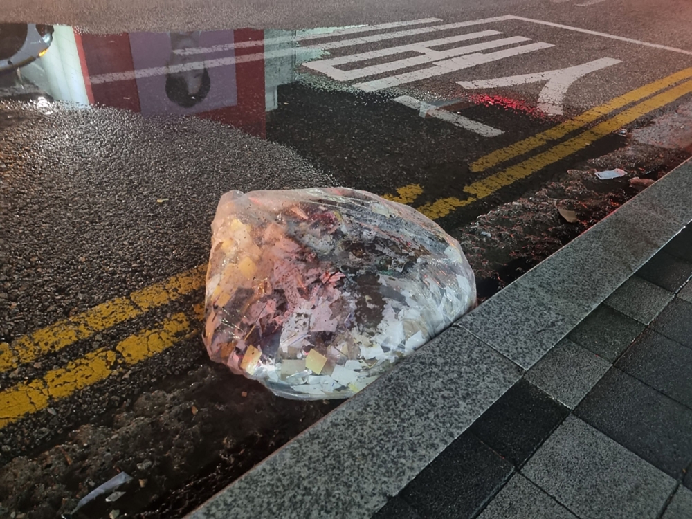 This handout photo taken between the night of June 1 and 2, 2024 and released on June 2, 2024 shows unidentified objects believed to be North Korean trash from balloons that crossed the inter-Korea border, on a street in Seoul. ― South Korean Defence Ministry/AFP pic