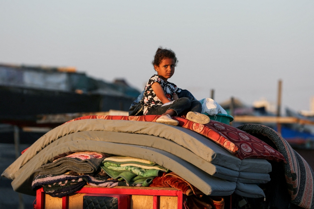 A Palestinian sits on top of belongings as he flees Rafah due to an Israeli military operation, amid the Israel-Hamas conflict, in Rafah, in the southern Gaza Strip, June 7, 2024. ― Reuters pic