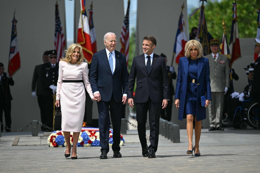 US President Joe Biden (second left), flanked by US First Lady Jill Biden (left), France’s President Emmanuel Macron (second right) and French president’s wife Brigitte Macron (right), walk as he participates in a ceremony as part of a state visit to France, at the Arc de Triomphe in Paris on June 8, 2024. ― AFP pic