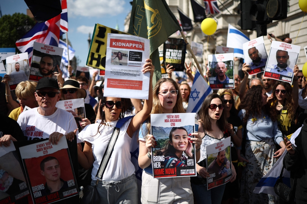 Protesters holding placards, including one of hostage Noa Argamani (centre), take part in a ‘United we Bring Them Home’ march, in central London, on June 2, 2024, to bring attention to the plight of the hostages still held in Gaza. ― AFP pic