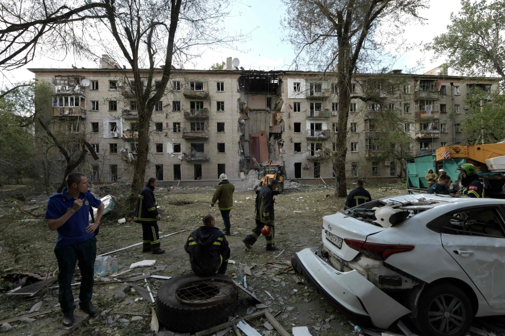 File photo of rescuers working at the site of a missile attack in Lugansk, Russian-controlled Ukraine, on June 7, 2024, amid ongoing Russian-Ukrainian conflict. ― AFP pic