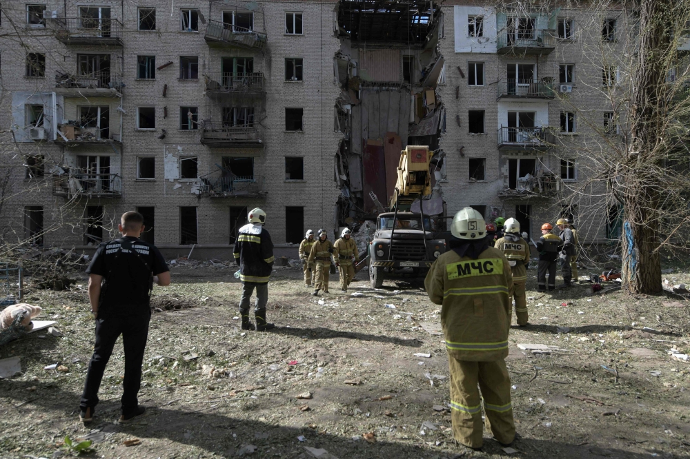File photo of rescuers clearing the rubble of a destroyed residential building following a missile attack in Lugansk, Russian-controlled Ukraine, on June 7, 2024, amid ongoing Russian-Ukrainian conflict. ― Reuters pic