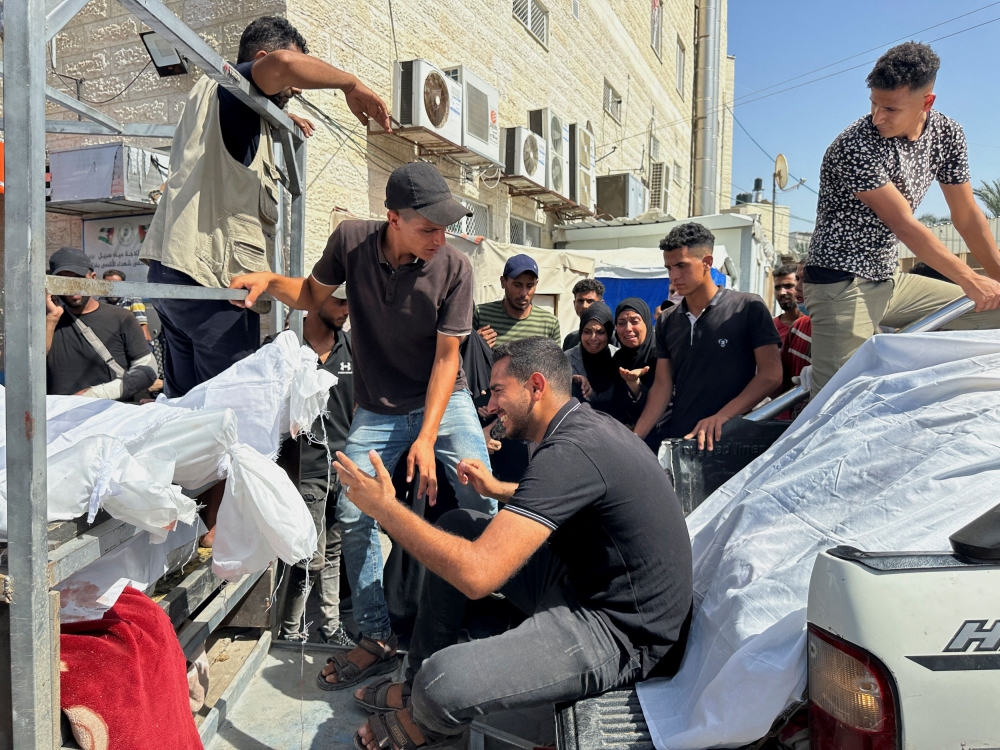 Mourners react during the funeral of Palestinians killed in Israeli strikes, amid the Israel-Hamas conflict, in Deir Al-Balah, in central Gaza Strip June 8, 2024. ― Reuters pic