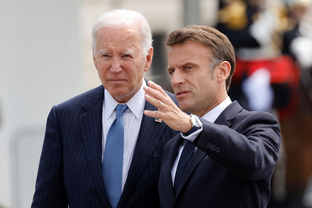 France’s President Emmanuel Macron welcomes US President Joe Biden before a ceremony at the Arc de Triomphe, in Paris, France on June 8, 2024. ― Reuters pic