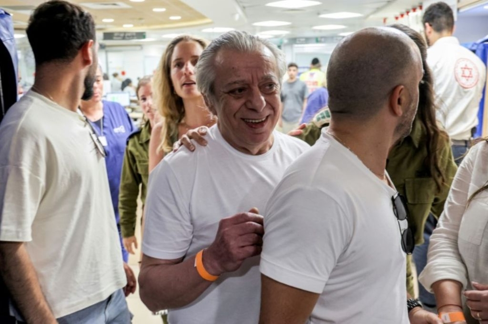 The father (centre) of freed hostage Shlomi Ziv arrives at Sheba Medical Center near Tel Aviv. — AFP pic