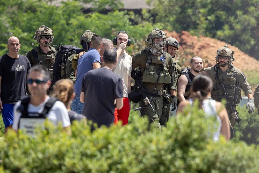 Released hostages Andrey Kozlov and Almog Meir Jan are escorted, after the military said that Israeli forces have rescued four hostages alive from the central Gaza Strip on Saturday, in Ramat Gan, Israel June 8, 2024. — Reuters pic