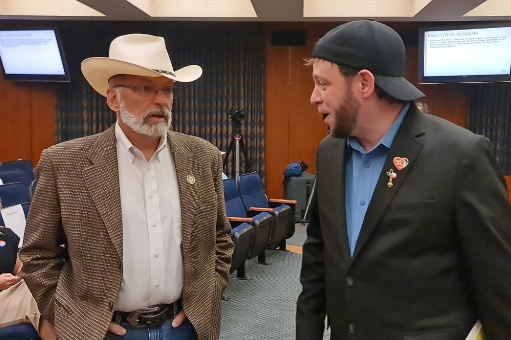 John Barrett (left), a conservative Amarillo resident, and Mark Lee Dickson (right), founder of the Sanctuary Cities for the Unborn initiative, talk during a council session where they requested authorities to allow civil suits against those who transport or help someone looking for an abortion using the city roads, during a council session at Amarillo City Hall in Amarillo, Texas, May 28, 2024. — AFP pic