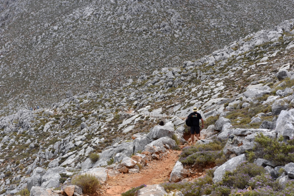A person walks on a rocky path, following the search for missing British TV doctor Michael Mosley on the island of Symi, Greece June 7, 2024. The deputy mayor on the island said Mosley’s body has been found today. — Reuters pic