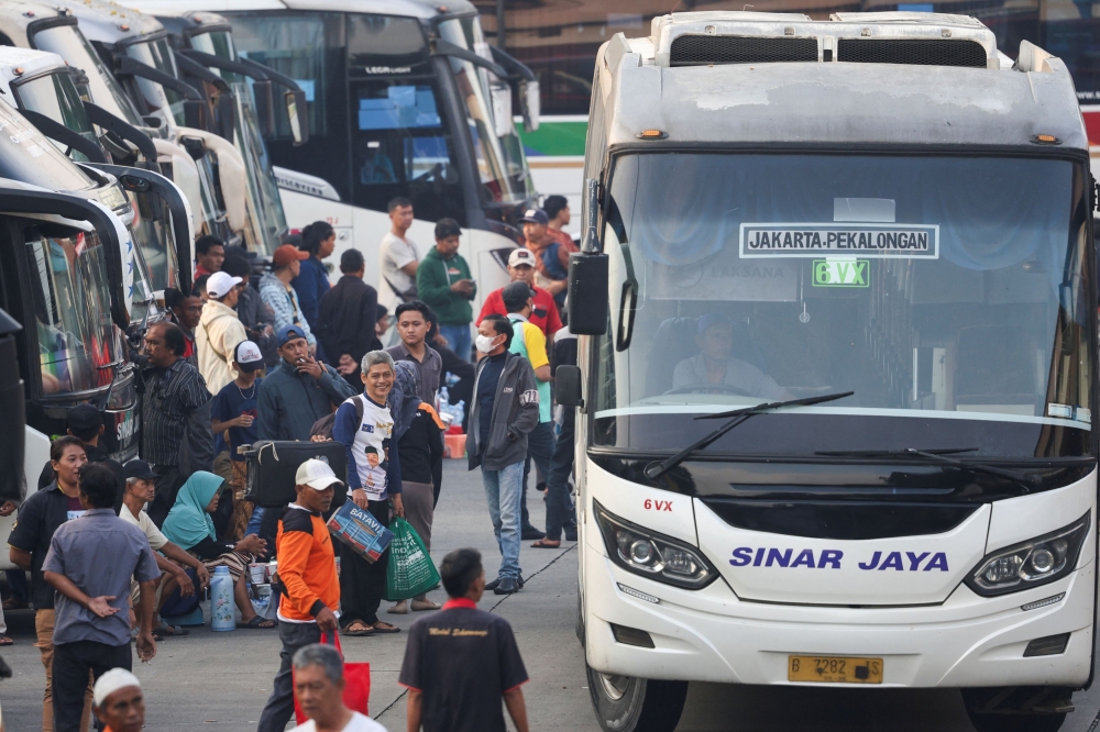 Passengers wait for a bus as people return to their hometowns, known locally as ‘mudik’, ahead of the Hari Raya Aidilfitri celebration, at Kampung Rambutan Terminal in Jakarta April 4, 2024. — Reuters pic