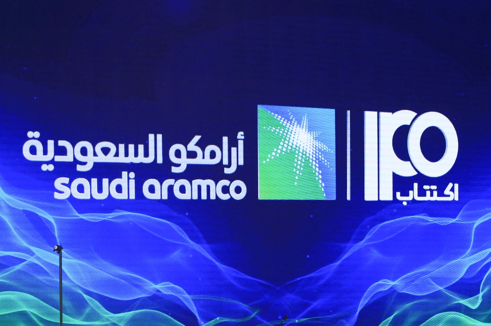 A picture taken on November 3, 2019 shows a sign of Saudi Aramco's initial public offering during a press conference by the state company in the eastern Saudi Arabian region of Dhahran. Aramco said today that international investors had snatched up the bulk of shares sold in its latest offering. — AFP pic