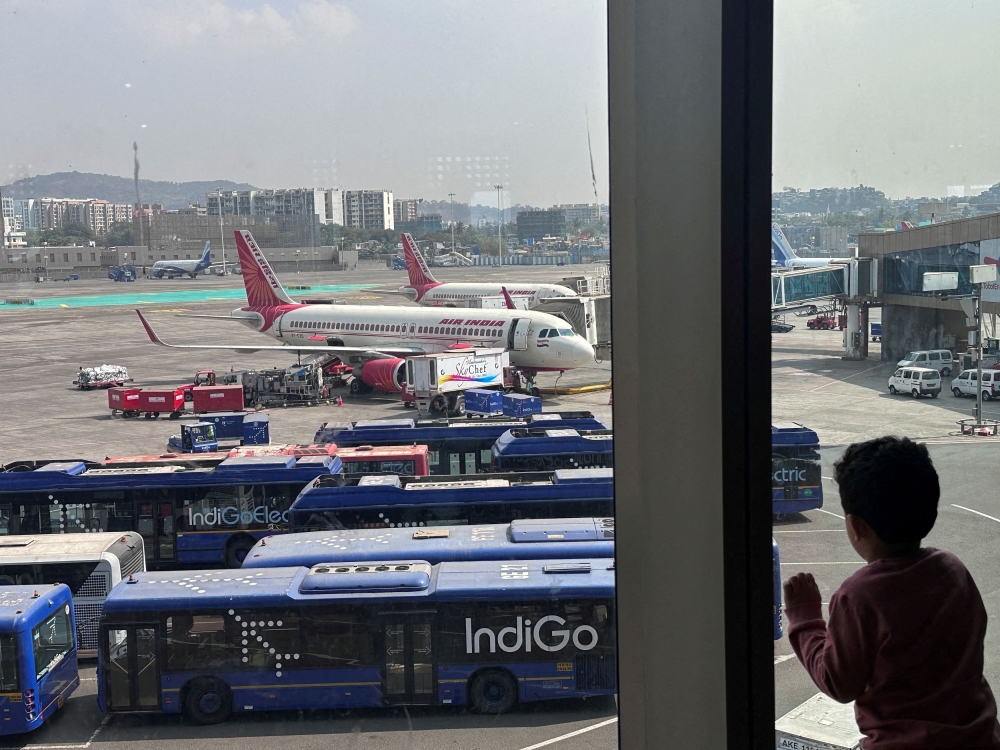 A boy looks at Air India airline passenger aircrafts parked at the Chhatrapati Shivaji Maharaj International Airport in Mumbai February 1, 2024. — Reuters pic  