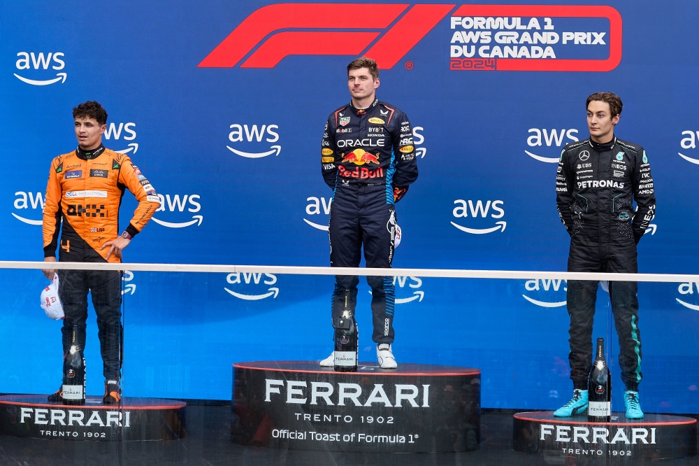 (From left) Second place, McLaren's British driver Lando Norris; winner, Red Bull Racing's Dutch driver Max Verstappen; and third place, Mercedes' British driver George Russell, stand on the podium after the 2024 Canada Formula One Grand Prix at Circuit Gilles-Villeneuve in Montreal June 9, 2024. — AFP pic