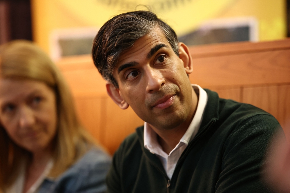 Britain's Prime Minister and Conservative Party leader, Rishi Sunak meets with Neighbourhood Watch representatives in Horsham, south of London on June 10, 2024 during a campaign event in the build-up to the UK general election on July 4. — Henry Nicholls/Pool/AFP pic 