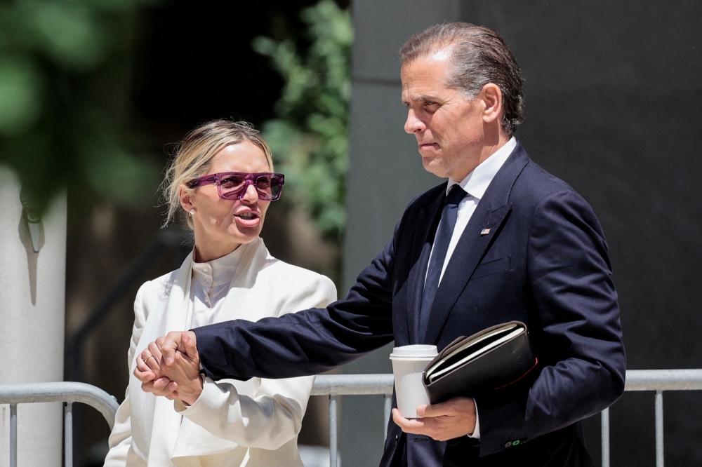 Hunter Biden, son of US President Joe Biden, and his wife Melissa Cohen Biden, depart the federal court during his trial on criminal gun charges in Wilmington, Delaware June 7, 2024. — Reuters pic  