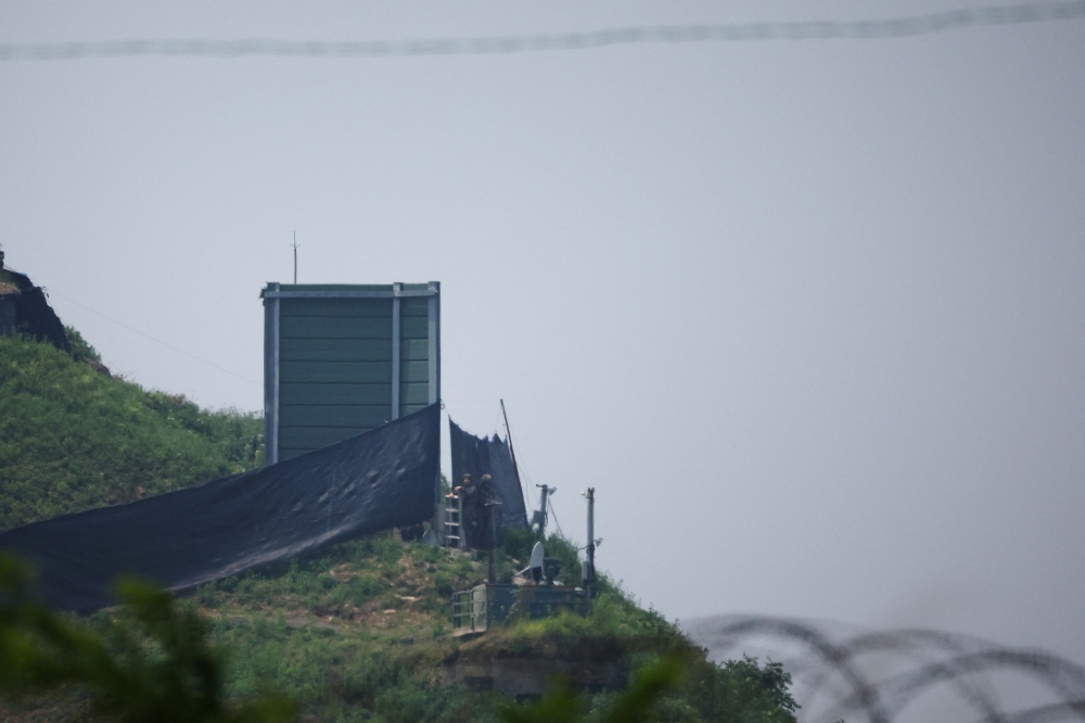 South Korean soldiers work next to a military facility (Green box) where loudspeakers dismantled in 2018 used to be, near the demilitarised zone separating the two Koreas in Paju, South Korea June 10, 2024. — Reuters pic   