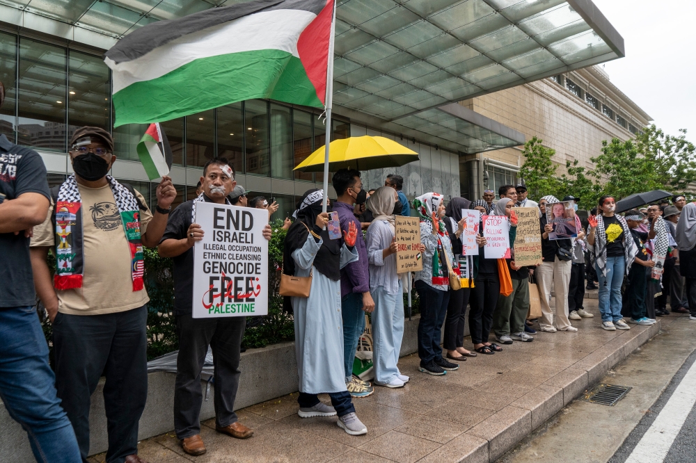 Demonstrators gather for the Palestine silent protest in conjunction of the United States’ Independence Day celebration in front of the Mandarin Oriental Kuala Lumpur on June 10, 2024. — Picture by Shafwan Zaidon
